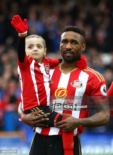 Bradley Lowery is held by Jermain Defoe of Sunderland as the teams line up prior to the Premier League match between Everton and Sunderland at...