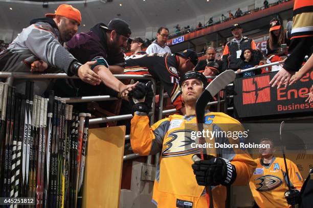 Ryan Getzlaf and Corey Perry of the Anaheim Ducks get high fives from fans as they take the ice to start the game against the Los Angeles Kings on...