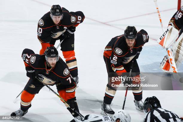 Joseph Cramarossa, Kevin Bieksa, and Corey Perry of the Anaheim Ducks line up for a face-off during the game against the Los Angeles Kings on...