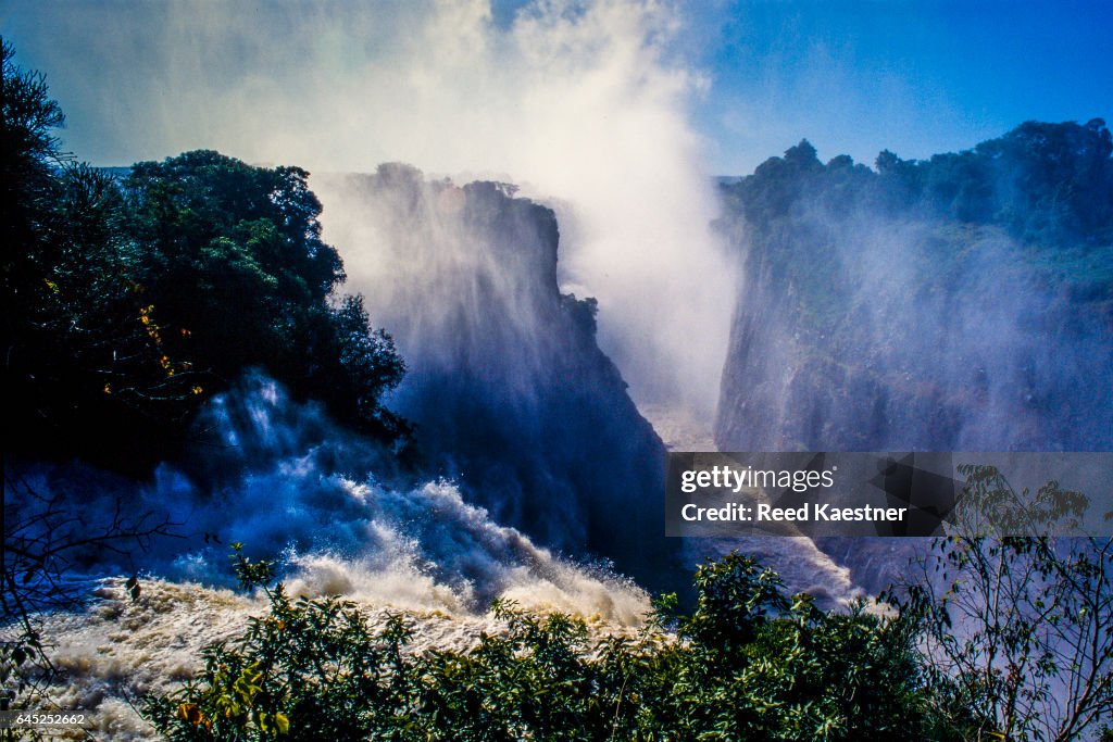 Billowing mist rises from the  Zambezi River as it  flows into the gorge at Victoria Falls