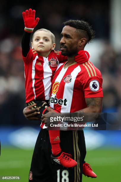 Sunderland mascot Bradley Lowery waves to the crowd as Jermaine Defoe looks on ahead of during the Premier League match between Everton and...