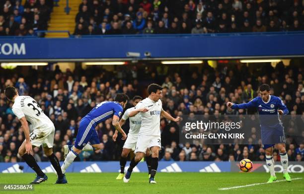 Chelsea's Spanish midfielder Cesc Fabregas scores the opening goal during the English Premier League football match between Chelsea and Swansea at...