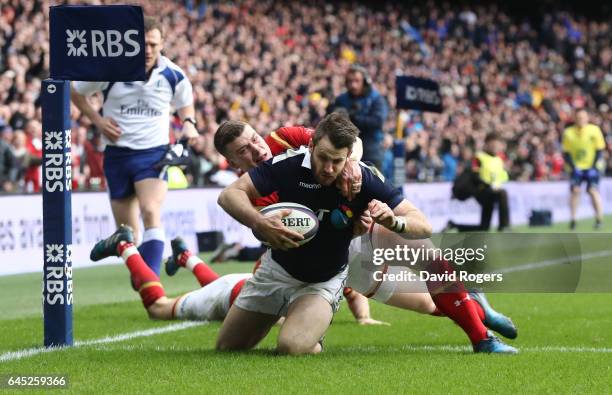 Tommy Seymour of Scotland goes past Liam Williams and Scott Williams of Wales to score his team's first try during the RBS Six Nations match between...