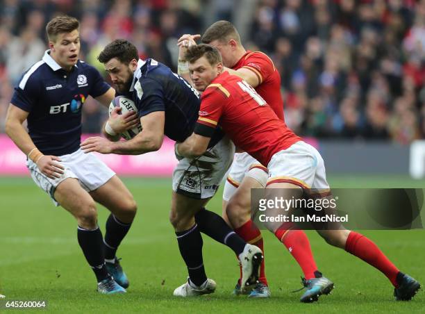 Alex Dunbar of Scotland is tackled by Dan Biggar of Wales during the RBS Six Nations match between Scotland and Wales at Murrayfield Stadium on...