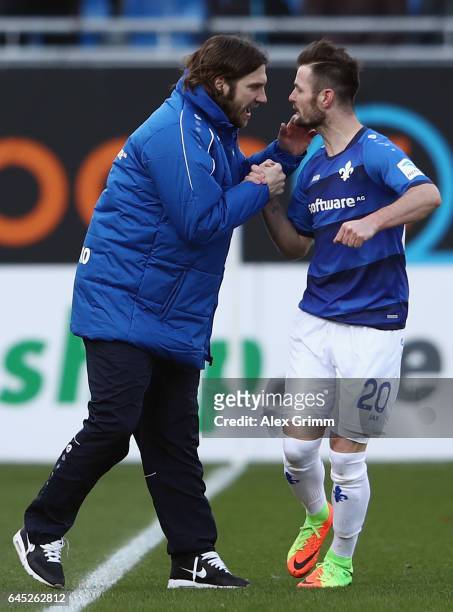 Marcel Heller of Darmstadt celebrates his team's first goal with head coach Torsten Frings during the Bundesliga match between SV Darmstadt 98 and FC...
