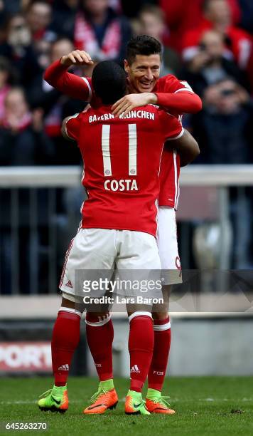 Robert Lewandowski of Muenchen celebrate with team mate Douglas Costa after he scores the 3rd goal during the Bundesliga match between Bayern...