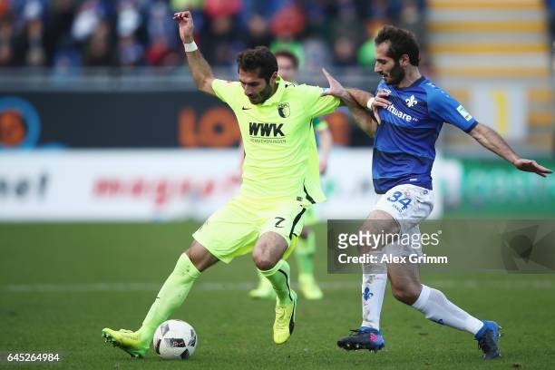 Halil Altintop of Augsburg is challenged by Hamit Altintop of Darmstadt during the Bundesliga match between SV Darmstadt 98 and FC Augsburg at...