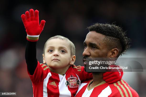 Sunderland mascot Bradley Lowery waves to the crowd as Jermaine Defoe looks on ahead of during the Premier League match between Everton and...