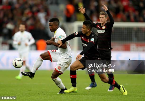 Benjamin Henrichs of Leverkusen and Copete Cordoba of Mainz battle for the ball during the Bundesliga match between Bayer 04 Leverkusen and 1. FSV...