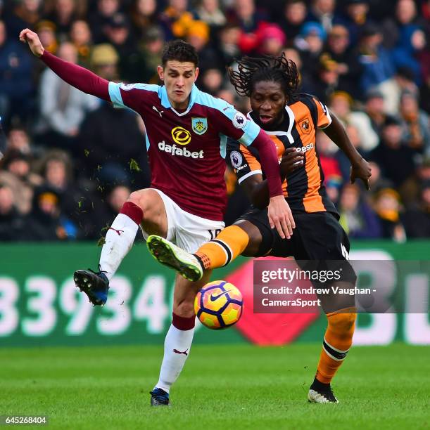 Burnley's Ashley Westwood vies for possession with Hull City's Dieumerci Mbokani during the Premier League match between Hull City and Burnley at...