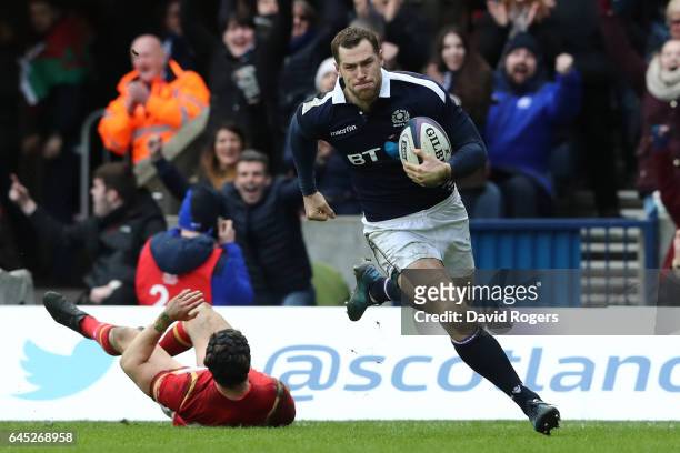Tim Visser of Scotland goes past Leigh Halfpenny of Wales to score his team's second try during the RBS Six Nations match between Scotland and Wales...