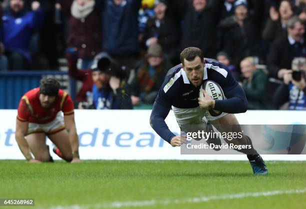 Tim Visser of Scotland goes past Leigh Halfpenny of Wales to score his team's second try during the RBS Six Nations match between Scotland and Wales...