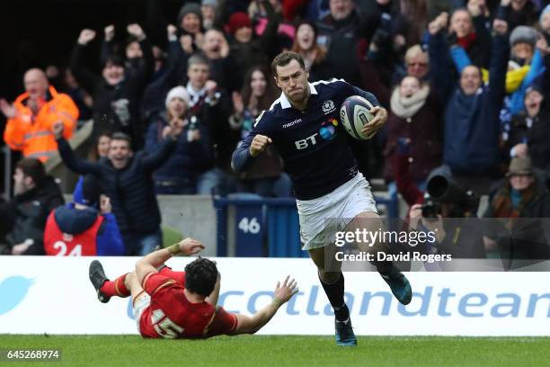 Tim Visser of Scotland goes past Leigh Halfpenny of Wales to score his team's second try during the RBS Six Nations match between Scotland and Wales...