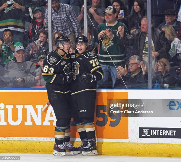 Janne Kuokkanen of the London Knights celebrates a goal with teammate Cliff Pu against the Windsor Spitfires during an OHL game at Budweiser Gardens...