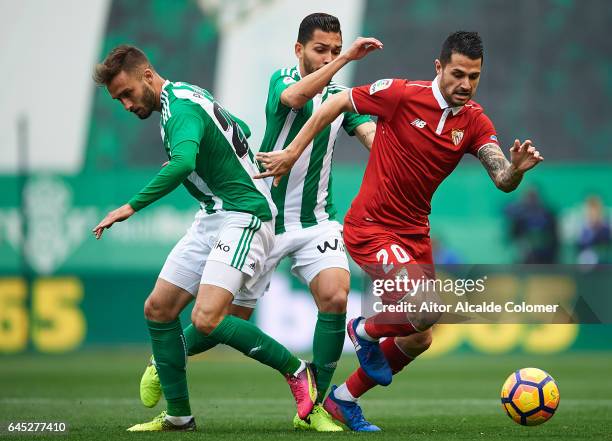 Victor Machin Perez "Vitolo" of Sevilla FC being followed by German Pezzella of Real Betis Balompie and Petros Matheus dos Santos of Real Betis...