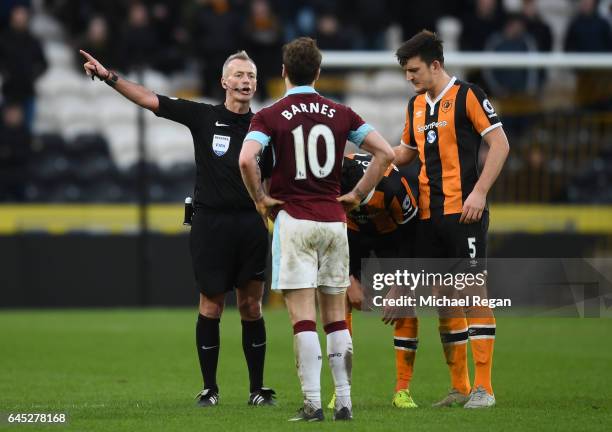 Referee Martin Atkinson speaks to Ashley Barnes of Burnley during the Premier League match between Hull City and Burnley at KCOM Stadium on February...
