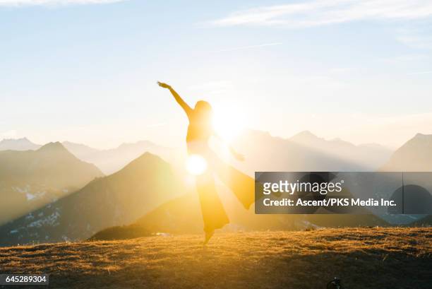dancer performs moves on mountain summit, sunrise - mountain woman ストックフォトと画像