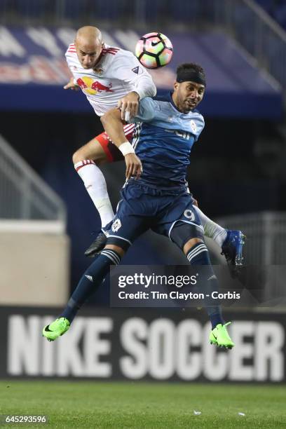 Aurelien Collin of New York Red Bulls heads clear while challenged by Giles Barnes of Vancouver Whitecaps during the New York Red Bulls Vs Vancouver...