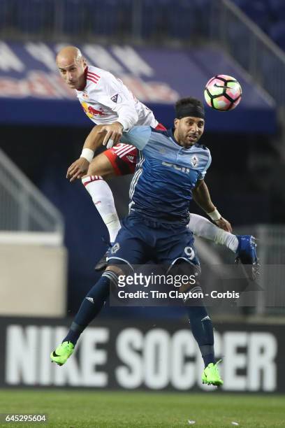 Aurelien Collin of New York Red Bulls heads clear while challenged by Giles Barnes of Vancouver Whitecaps during the New York Red Bulls Vs Vancouver...