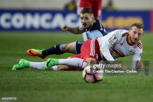 Daniel Royer of New York Red Bulls after diving over Jordan Harvey of Vancouver Whitecaps as they challenge for the ball during the New York Red...