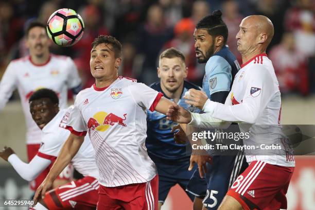 Aaron Long of New York Red Bulls in action watched by Sheanon Williams of Vancouver Whitecaps and Aurelien Collin of New York Red Bulls during the...