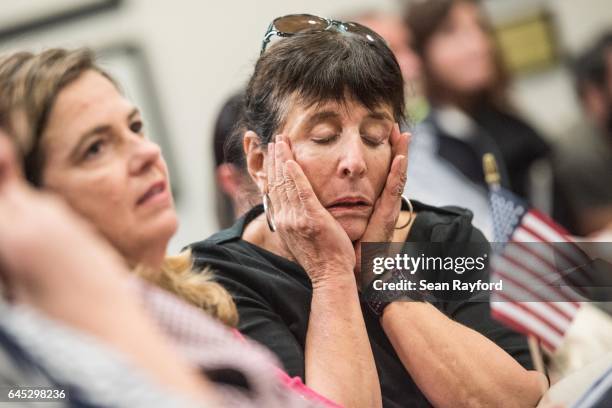 Woman reacts to a response from Sen. Tim Scott , during a town hall meeting with at the Charleston County Council Chambers on February 25, 2017 in...