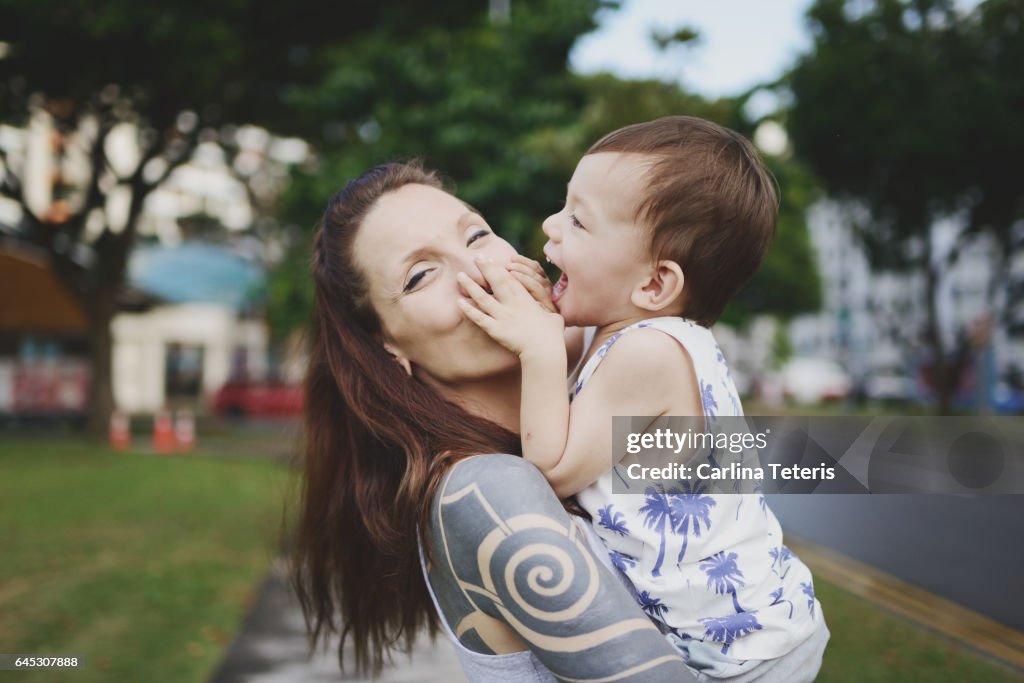 Woman and her son having fun in a city park