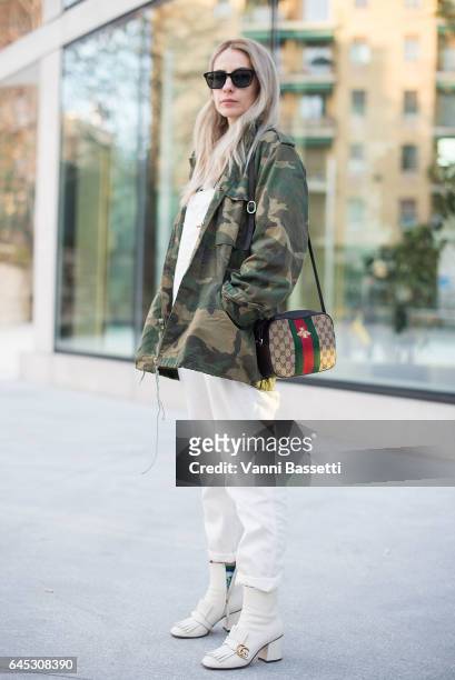 Guest poses wearing a Carhartt overall and Gucci bag and shoes before the Agnona show during Milan Fashion Week Fall/Winter 2017/18 on February 25,...