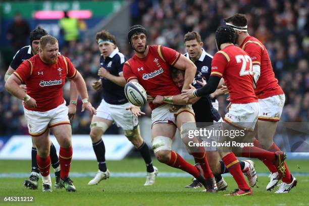 Luke Charteris of Wales offloads in the tackle during the RBS Six Nations match between Scotland and Wales at Murrayfield Stadium on February 25,...