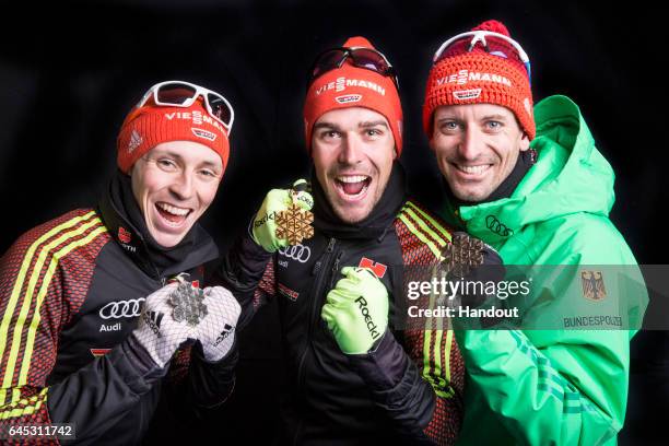 In this handout supplied by NordicFocus, Gold medallist Johannes Rydzek of Germany, silver medallist Eric Frenzel of Germany and Bjoern Kircheisen of...