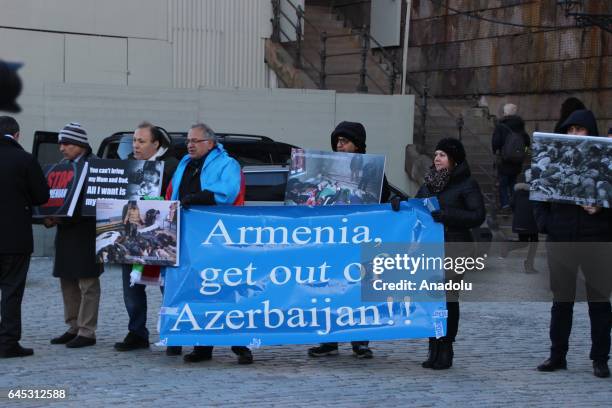 People attend a rally on the 25th anniversary of the Khojaly Massacre, in front the Parliament building in Stockholm, Sweden on February 25, 2017....