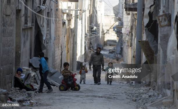 Civilians are seen in the Syrian town of Al Bab after the town center has been entirely freed from Daesh terrorists by Free Syrian Army , backed by...