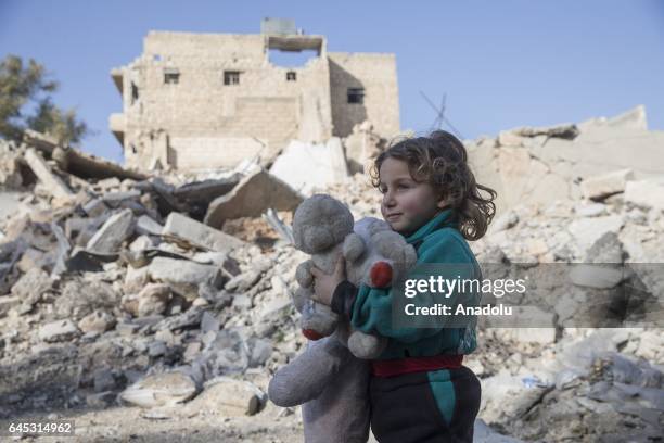 Girl holds a teddy bear in the Syrian town of Al Bab after the town center has been entirely freed from Daesh terrorists by Free Syrian Army , backed...