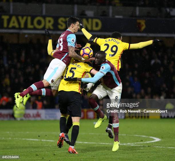 West Ham United's Cheikhou Kouyate and Jose Fonte challenge Watford's Craig Cathcart and Etienne Capoue during the Premier League match between...