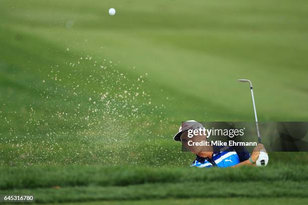 Rickie Fowler of the United States plays a shot from a bunker on the fourth hole during the third round of The Honda Classic at PGA National Resort...