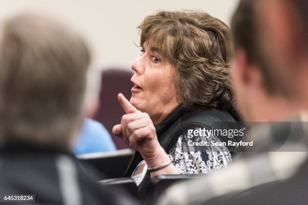 Woman chastises a man seated behind her during during a town hall meeting with Sen. Tim Scott at the Charleston County Council Chambers on February...