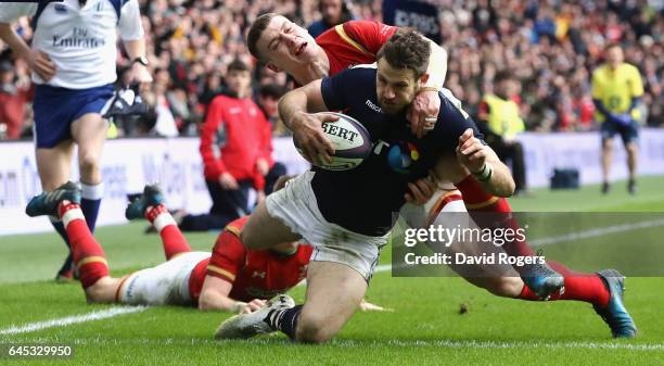 Tommy Seymour of Scotland goes past Liam Williams and Scott Williams of Wales to score his team's first try during the RBS Six Nations match between...