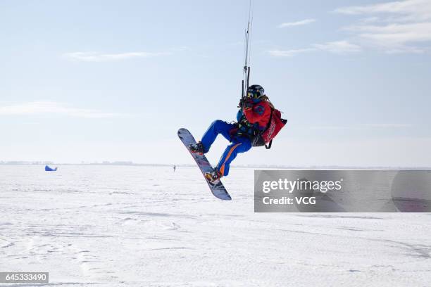 Man flies a kite during the second "Lianhuan Lake Cup" Kite Competition at Lianhuan Lake Hot Spring Resort of Duerbote County on February 25, 2017 in...