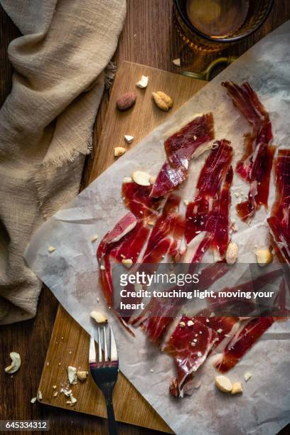 food photography - jamon iberico bellota with nuts - serrano ham stock pictures, royalty-free photos & images