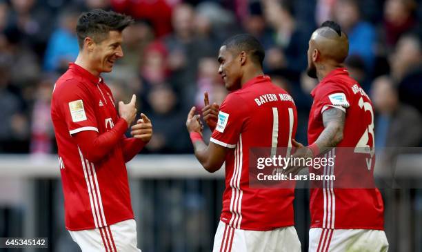 Robert Lewandowski of Bayern Muenchen celebrates with Douglas Costa of Bayern Muenchen during the Bundesliga match between Bayern Muenchen and...