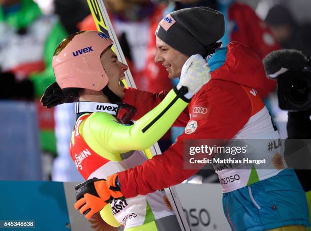 Stefan Kraft of Austria celebrates with his teammate Manuel Fettner of Austria after his final jump in the Men's Ski Jumping HS100 Final during the...