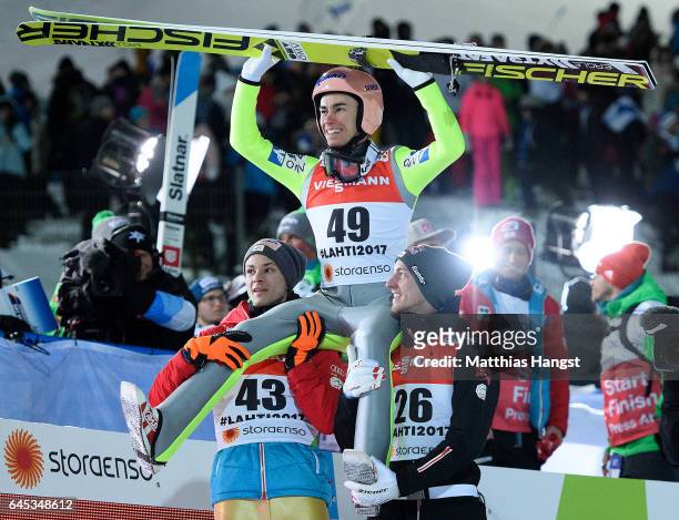 Stefan Kraft of Austria celebrates with his teammates Manuel Fettner of Austria and Gregor Schlierenzauer of Austria after his final jump in the...