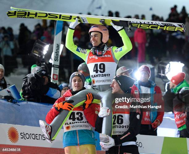 Stefan Kraft of Austria celebrates with his teammates Manuel Fettner of Austria and Gregor Schlierenzauer of Austria after his final jump in the...