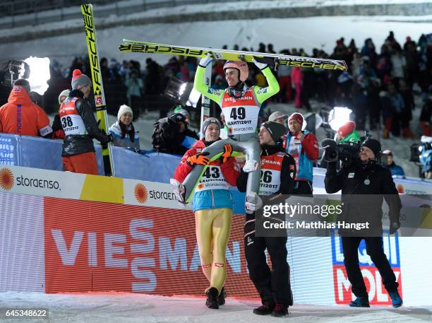 Stefan Kraft of Austria celebrates with his teammates Manuel Fettner of Austria and Gregor Schlierenzauer of Austria after his final jump in the...