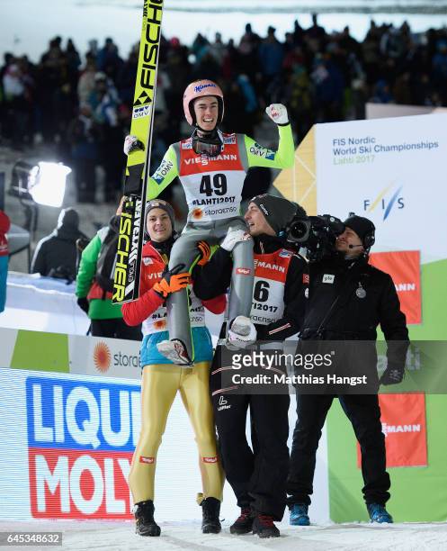 Stefan Kraft of Austria celebrates with his teammates Manuel Fettner of Austria and Gregor Schlierenzauer of Austria after his final jump in the...