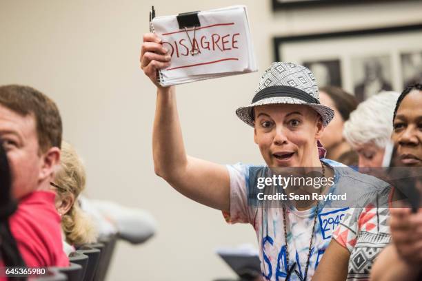 Woman disagrees with an answer to a question during a town hall meeting with Sen. Tim Scott at the Charleston County Council Chambers on February 25,...