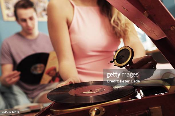 young couple in bedroom with record player - vinyle bildbanksfoton och bilder