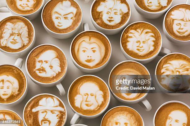 latte art faces in cups of coffee - coffee art stockfoto's en -beelden