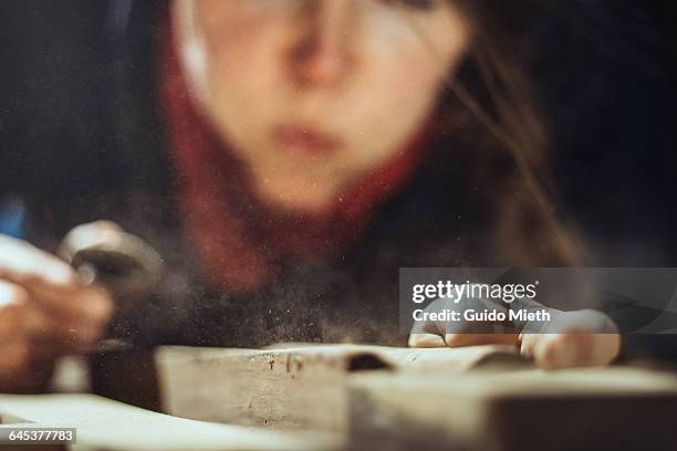 woman blowing away wood shavings. - woman sleep stockfoto's en -beelden