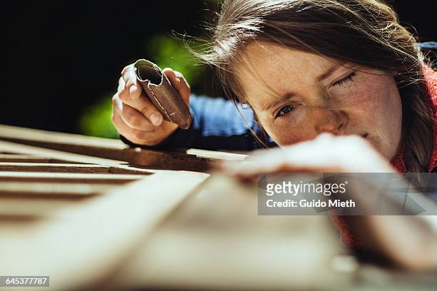 woman checking her work. - diy stock-fotos und bilder